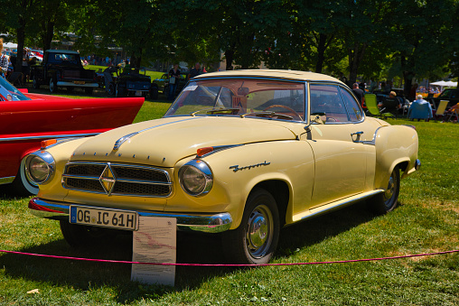 Baden-Baden, Germany - 10 July 2022: beige yellow Borgward Isabella 1954 is parked in Kurpark in Baden-Baden at the exhibition of old cars \