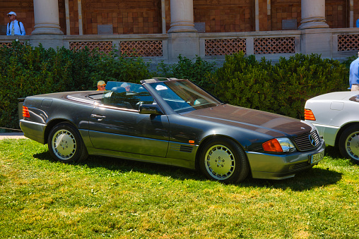 Baden-Baden, Germany - 10 July 2022: gray grey Mercedes-Benz R129 SL 1989 cabrio roadster is parked in Kurpark in Baden-Baden at the exhibition of old cars 