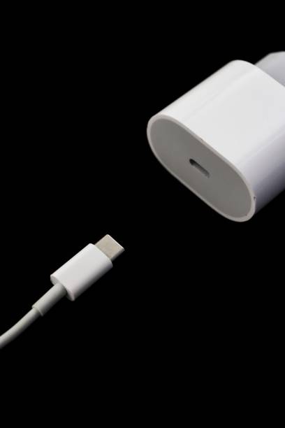 istock White european plug charger block and type-c cable on the left isolated on black background 1441031855