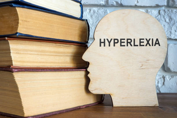 istock Wooden head with word hyperlexia and books. 1441031856