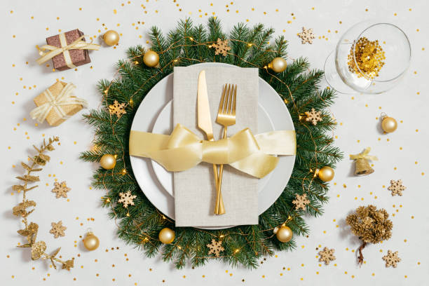istock Golden Christmas table setting with gold accessories on a gray table. Preparing for Christmas dinner. Top view, flat lay. 1441033942