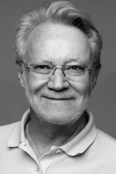Smiling mature senior caucasian man looking away