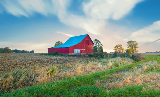 American flag painted on barn behind fence, located in Litchfield, Connecticut, USA