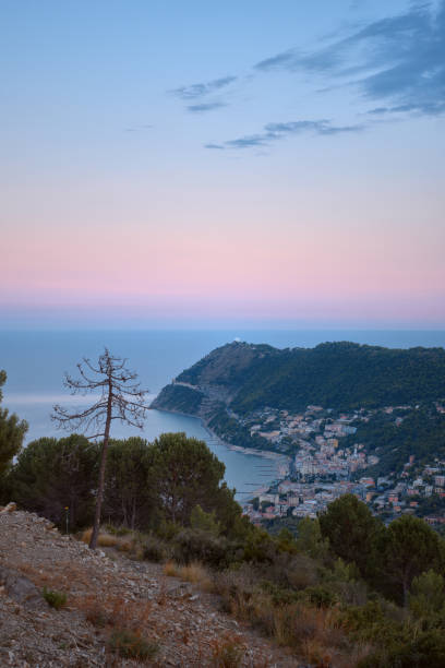 Summer view of the coastal town on the Italian Riviera from the mountain at sunset stock photo