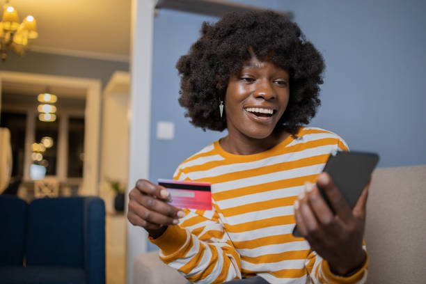 istock Cheerful  woman doing online shopping 1441045016
