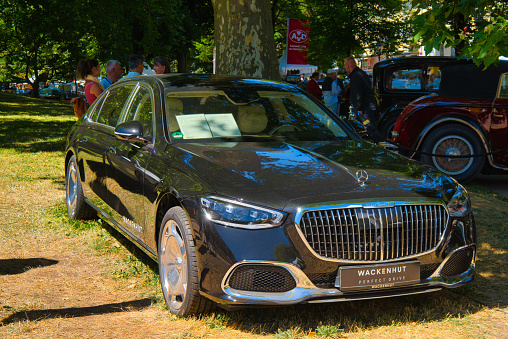 Baden-Baden, Germany - 10 July 2022: black Mercedes-Benz S-Class Mercedes-Maybach 580 4M X223 W223 2020 is parked in Kurpark in Baden-Baden at the exhibition of old cars \