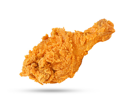 Fried chicken leg falling in the air isolated on white background.