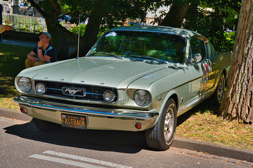 Baden-Baden, Germany - 10 July 2022: grey gray Ford Mustang Fastback sport coupe 1967 is parked in Kurpark in Baden-Baden at the exhibition of old cars \