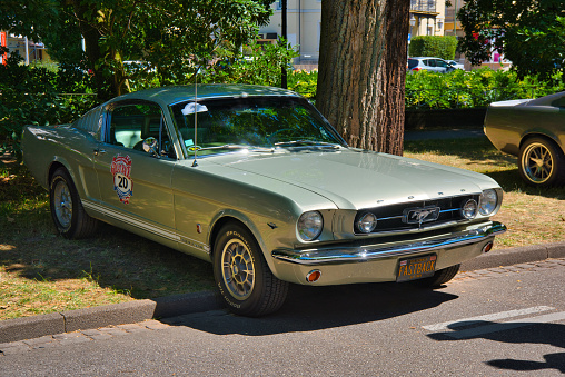 A green colored 1967 Ford Mustang is parked in a parking lot in Fort Langley, BC, Canada.