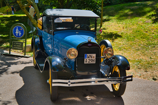 Baden-Baden, Germany - 10 July 2022: blue yellow Ford Model A T 1927 1931 truck is parked in Kurpark in Baden-Baden at the exhibition of old cars \