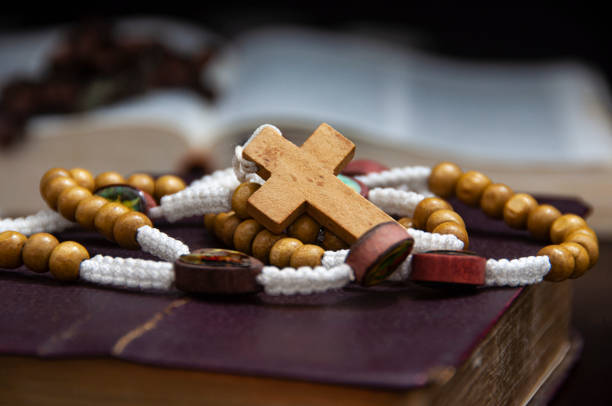 istock Holy Rosary on Bible with customizable space for religious text or ideas. 1441053246