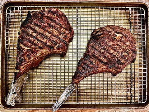 Two huge tomahawk steaks.