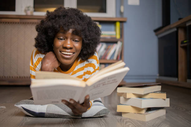 istock Woman relaxing and reading a book 1441059689