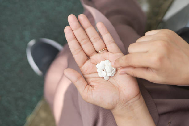 istock young women taking medical pills top view 1441062421