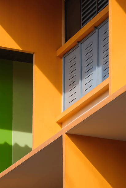 istock Geometric pattern of colorful shading fin concrete with steel windows with light and shadow on surface of modern building wall in vertical frame 1441065699