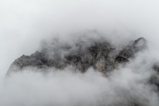 Rocky spires in the Cordillera Huayhuash in the Peruvian Andes shrouded in clouds