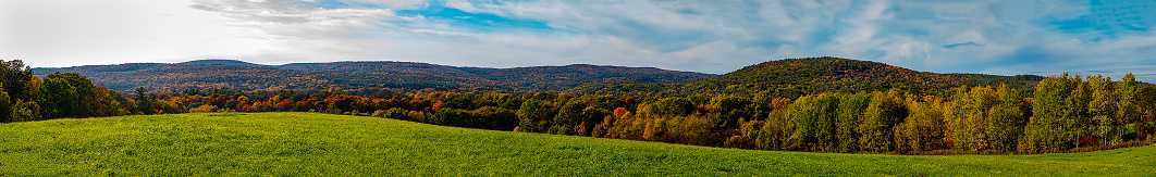 Panoramic scenic fall foliage over farmland off of SR 11 in New Hampshire near the Connecticut River.