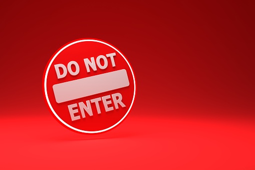 Red Do Not Enter road sign isolated on a red background lit from above 3D render