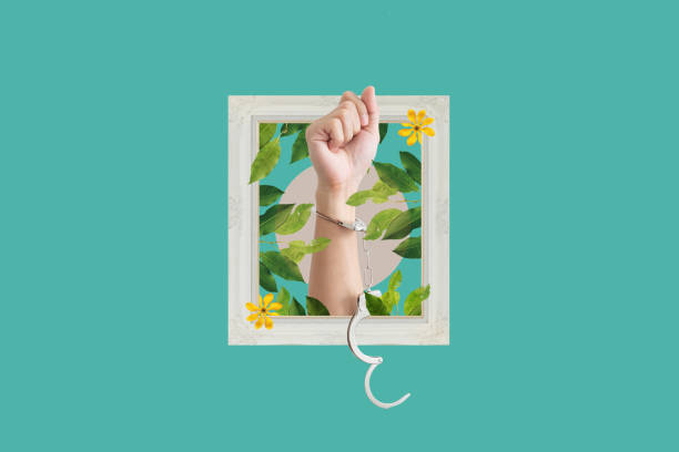 istock Digital collage modern art. Hand raised with handcuff and leaves, flowers in frame 1441075643