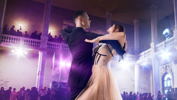 istock Couple dancers perform waltz on large professional stage. 1441093329