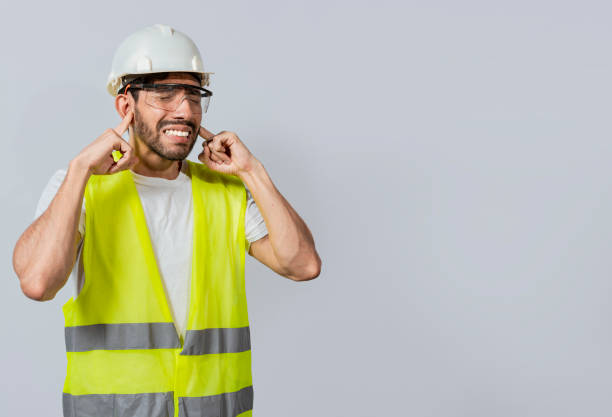 istock Engineer with ear pain isolated, Young engineer covering his ears isolated, Builder man with ear pain, Concept of engineer covering his ears with pain expression. 1441095431