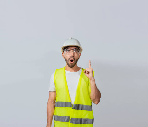 istock Amazed engineer man pointing up, Surprised young architect pointing up, Amazed engineer pointing at an advertisement. Concept of an engineer with astonished face pointing at blank space 1441095432