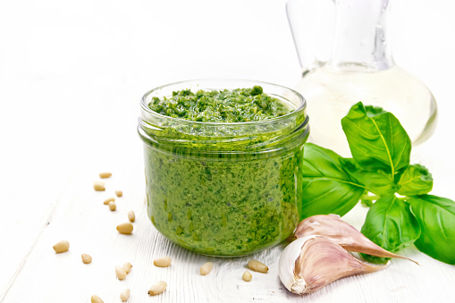 Homemade pesto made from fresh ramsons or wild garlic on wooden background.