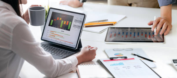 istock Two young business people working together, using digital tablet analysing and discussing business growth graph at office. 1441098058