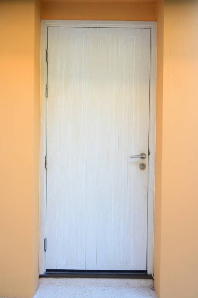 istock old white door and orange wall, construction industry 1441102565