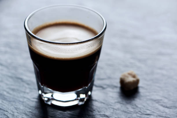 istock Coffee in glass cup on dark stone background. Close up. 1441103320