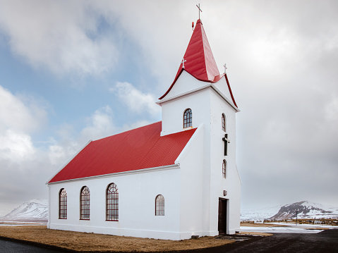 Snæfellsnes Peninsula - The historic Ingjaldshóll Church in Wintertime. The church at Ingjaldsholl serves the villages Hellisandur and Rif and is the oldest concrete church in the world. Christopher Columbus seems to have stayed at Ingjaldshóll during the winter of 1477-78. Ingjaldshólskirkja - Ingjaldsholl Church, Snæfellsnes Peninsula in West-Iceland, Iceland, Northern Europe.