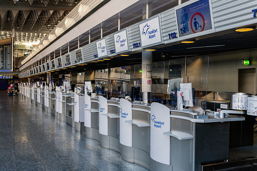 Frankfurt, Germany - October 30, 2022: Inside a terminal of Frankfurt International Airport with a lot of check in counters in a row. Frankfurt am Main Airport is a major international airport located in Germany.