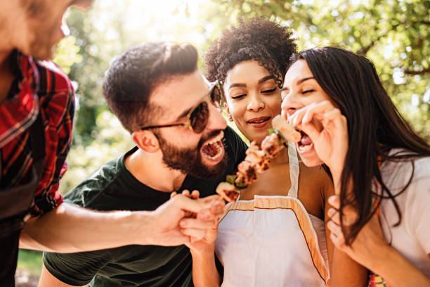 Friends having fun eating together at Barbecue