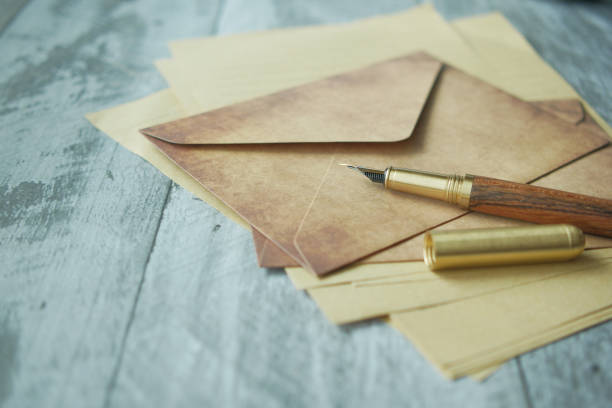 istock envelope , empty paper and fountain pen on table 1441106186
