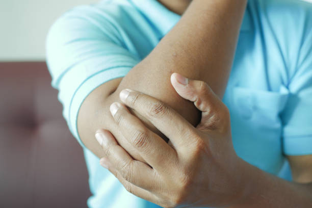 istock young man suffering pain on elbow sitting on sofa 1441107522