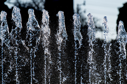 In the fountain, the fluid flows under high pressure and bubbles form
