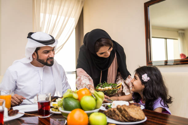 istock Arabian family having meal at home 1441120370