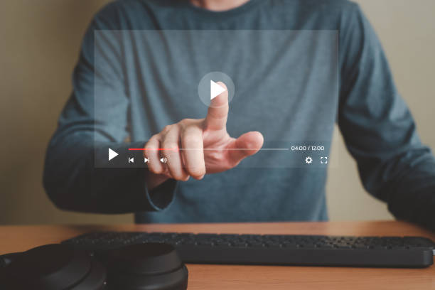istock Selective focus at finger that push on press play button for start online entertainment for on demand video streaming service that online over internet which include movie or music. 1441120599