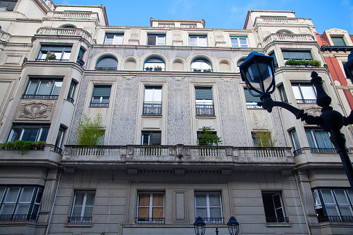 facades of old residential buildings. Windows, balconies, stone, brick, concrete.