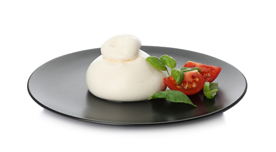 Delicious burrata cheese with basil and tomato on white background