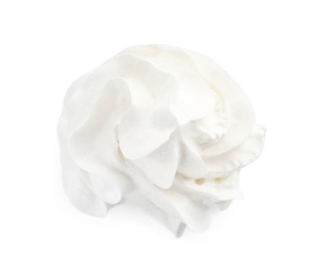 istock Delicious whipped cream isolated on white, top view 1441122984