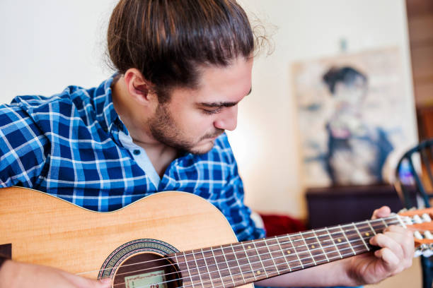 istock Learning to Play Guitar at Home 1441123933