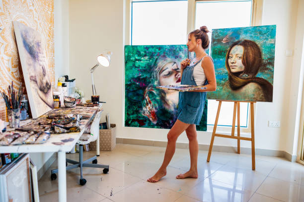 istock Artist admiring her new painting 1441124065