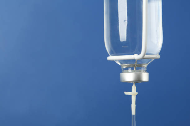 istock IV infusion set on blue background, closeup. Space for text 1441125603