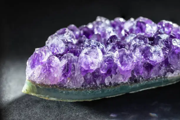 Amethyst Crystal Cluster a Purple Variety of Quartz over Black Background. Healing Crystal Concept, Amethyst is Good for Relieve Anxiety and Stress. Natural Mineral Stone Collection