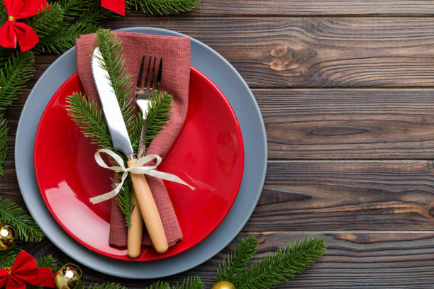 istock Christmas table place setting with christmas decor and plates, kine, fork and spoon. Christmas holiday background. Top view with copy space 1441127791