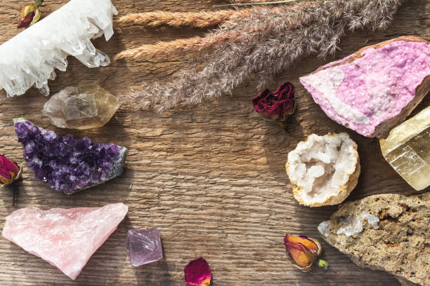 Healing Crystal Stones for Wicca or Reiki Practice Flat Lay of Multiple Gemstones and Minerals on the Wooden Table with the Copy Space in the Middle. Healing Crystal Stones for Wicca or Reiki Witchcraft Practice crystal altar stock pictures, royalty-free photos & images