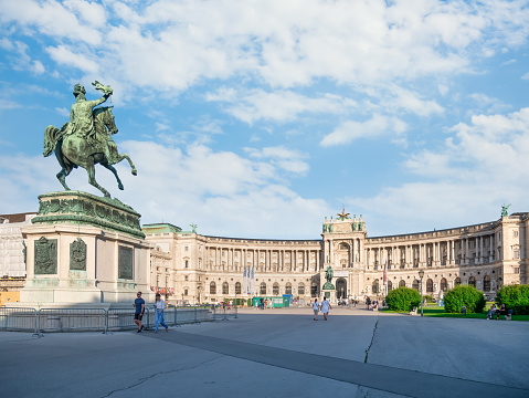 Vienna, Austria - June 2022: View with the facade of The Hofburg baroque palace from Heldenplatz square