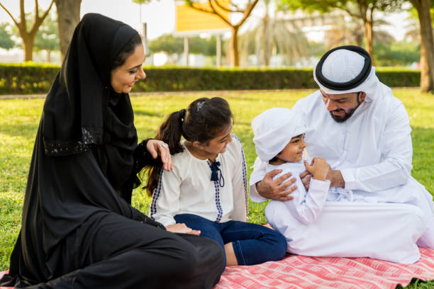 istock Happy arabian family in a park 1441129554
