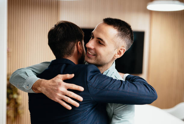 istock Diverse business people in office hugging after farewell 1441132673